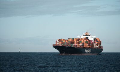 Hapag-Lloyd container vessel loaded with shipping containers on a calm sea under sunny weather