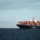 Hapag-Lloyd container vessel loaded with shipping containers on a calm sea under sunny weather