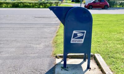 A US Postal Service Mailbox on a suburban street