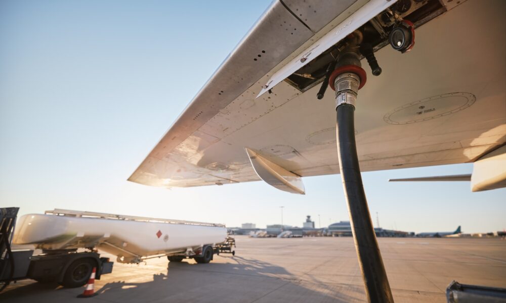 Refueling of airplane at airport. Ground service before flight.